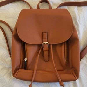 Mini brown leather backpack.